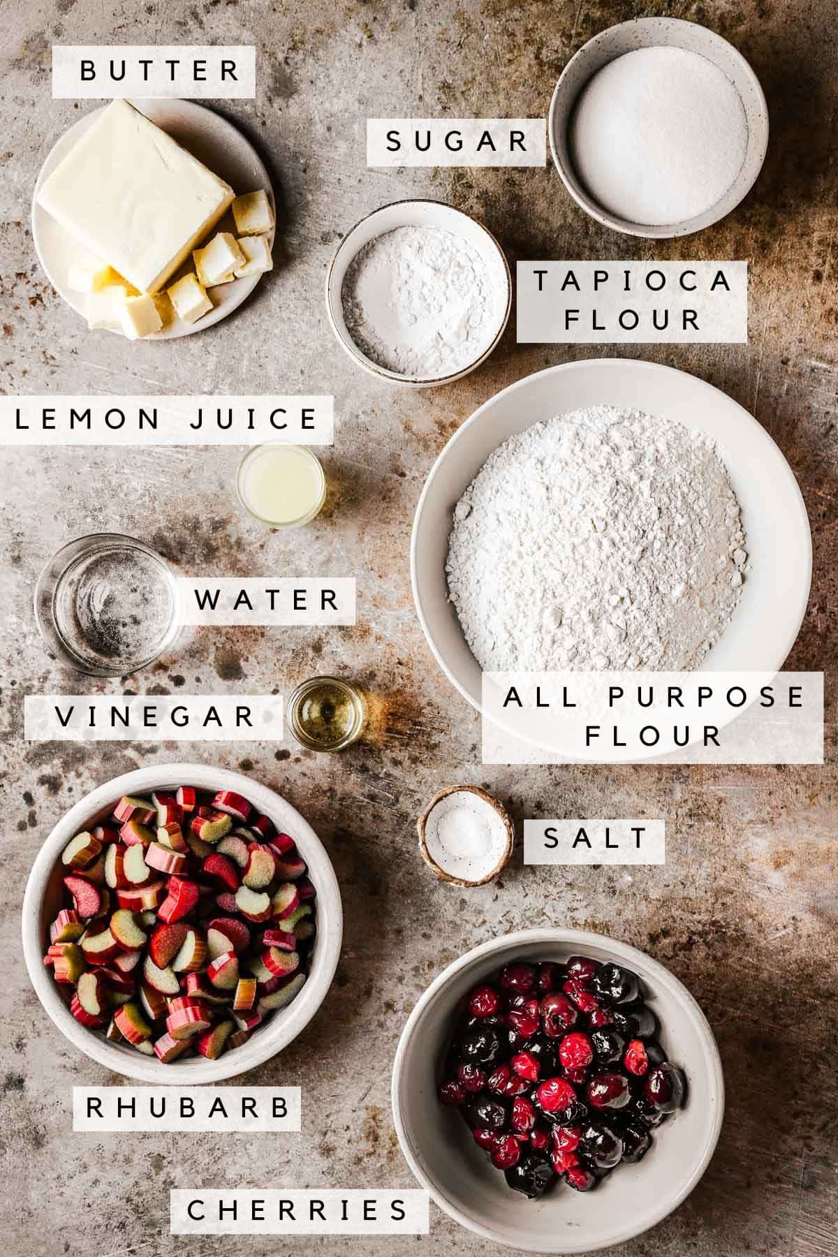 Labeled ingredients in bowls for cherry rhubarb pie recipe.