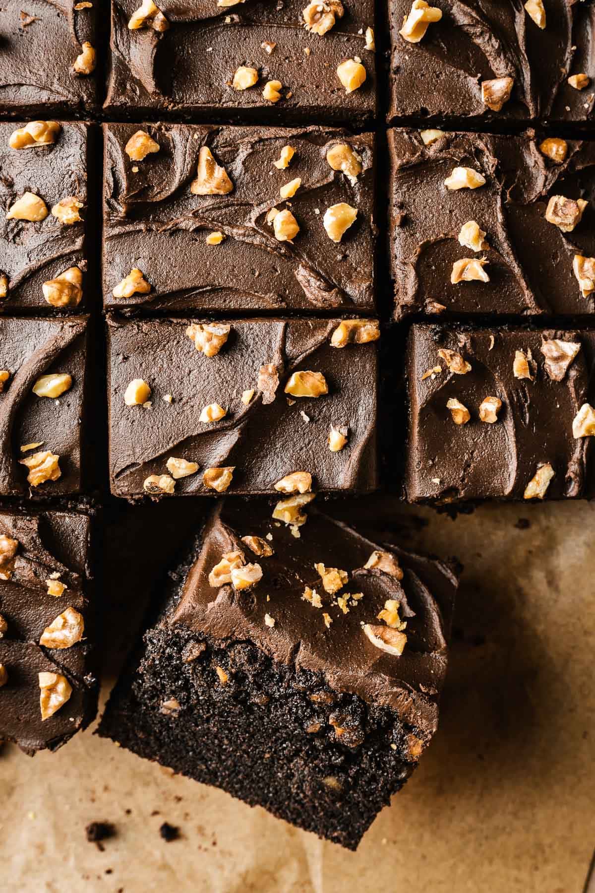 Slices of chocolate walnut cake with one slice turned at an angle to show the crumb.