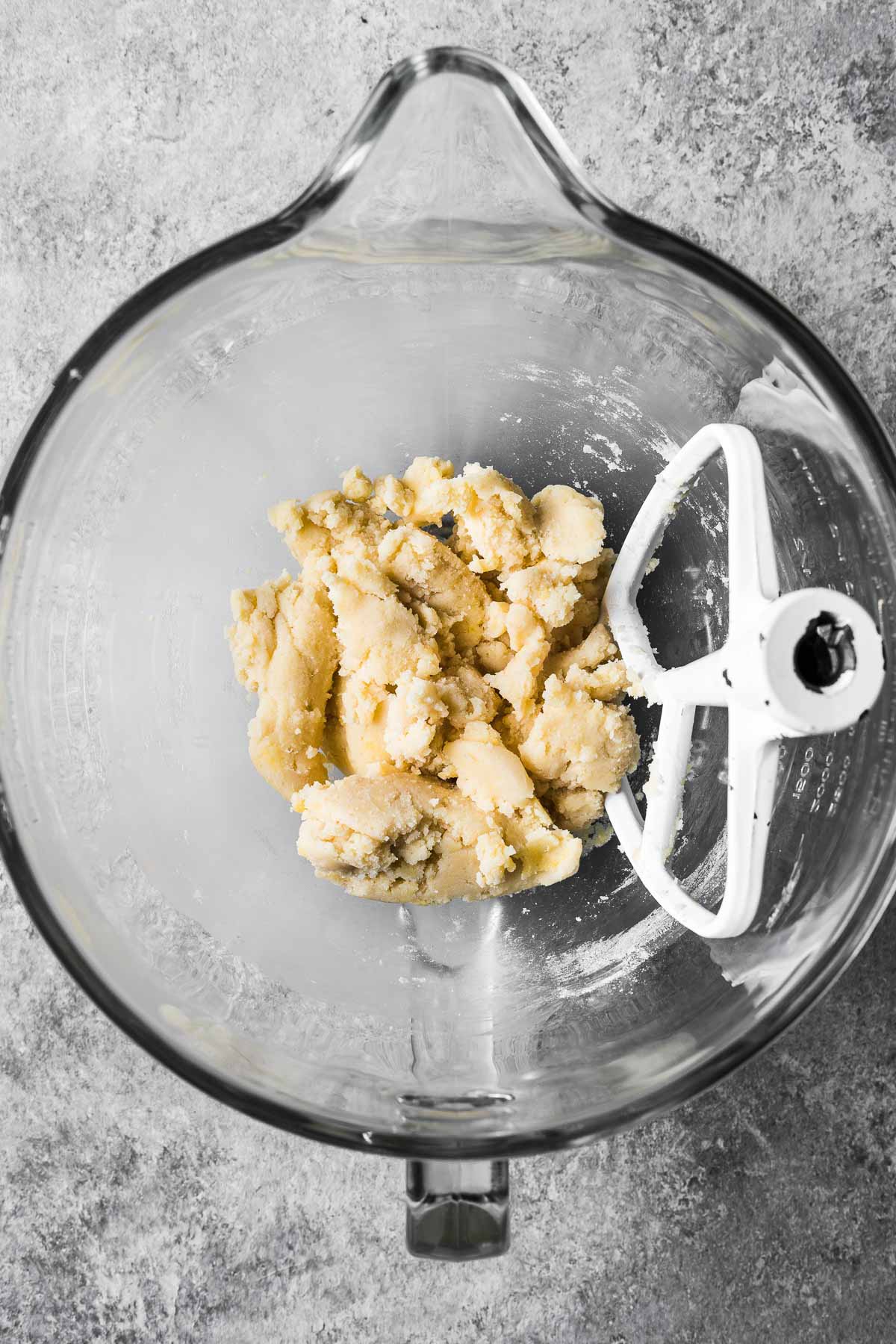 A glass mixing bowl with pate sucree dough.