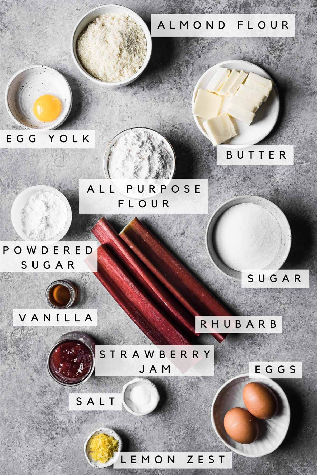 Labeled ingredients in bowls for rhubarb frangipane tart.