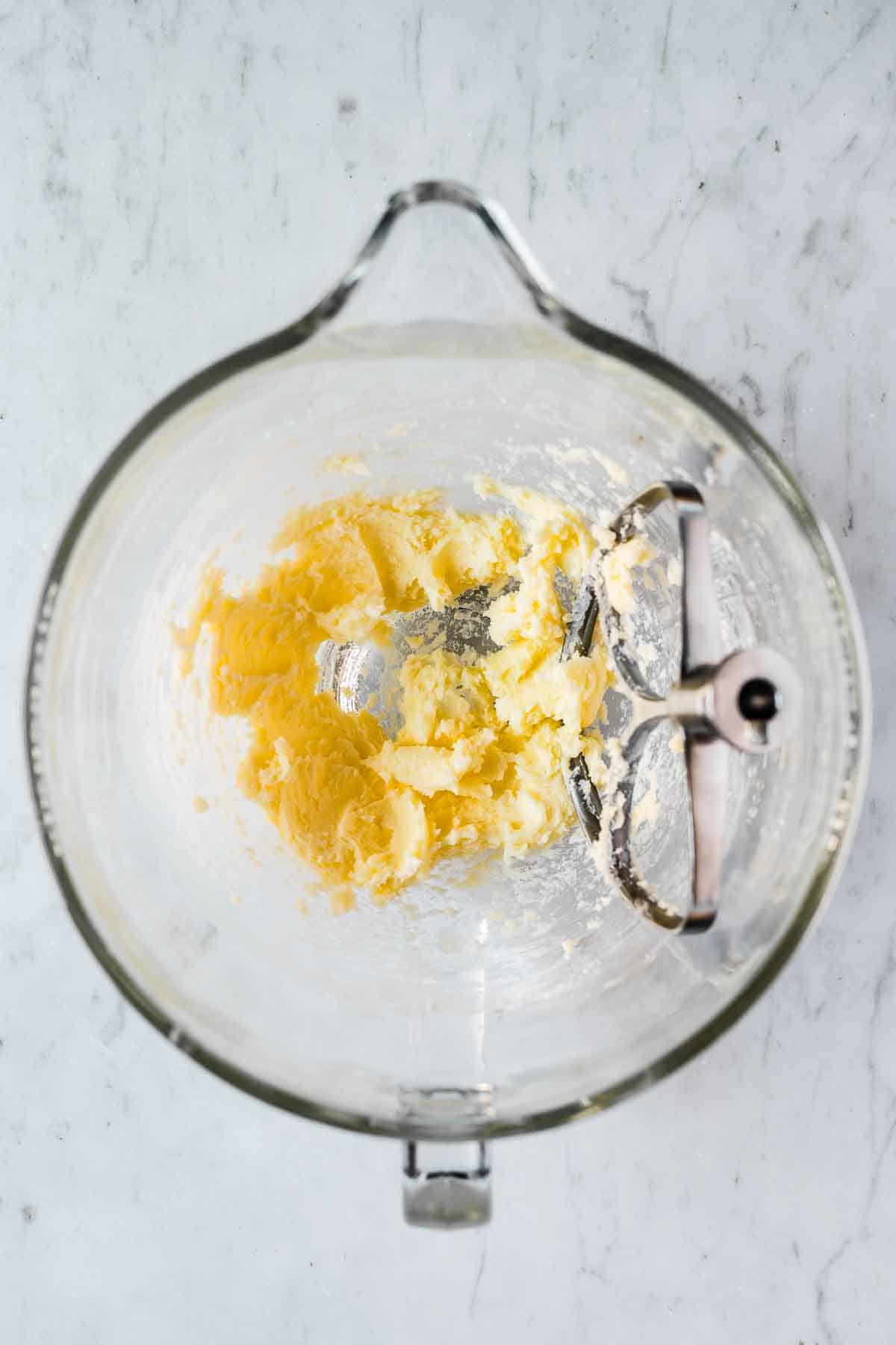 Mixing bowl with blended butter and sugar.