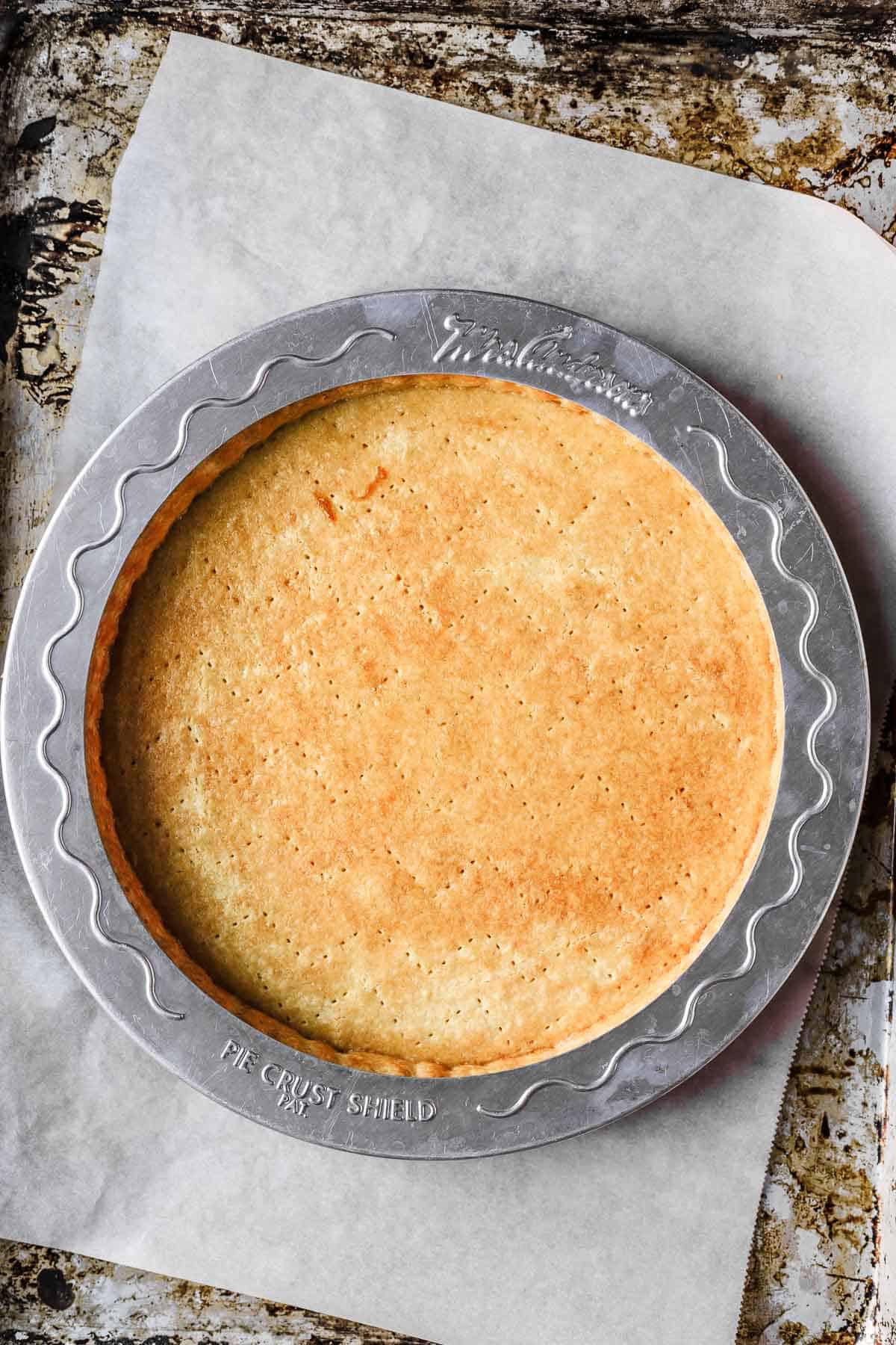 Baked tart crust with a pie shield on the outside crust to keep it from getting too dark.