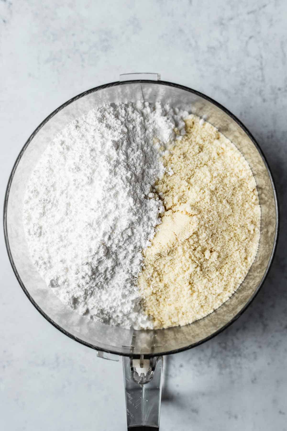 Almond flour and powdered sugar added to food processor.