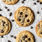 Baked coconut chocolate chip cookies on parchment paper.