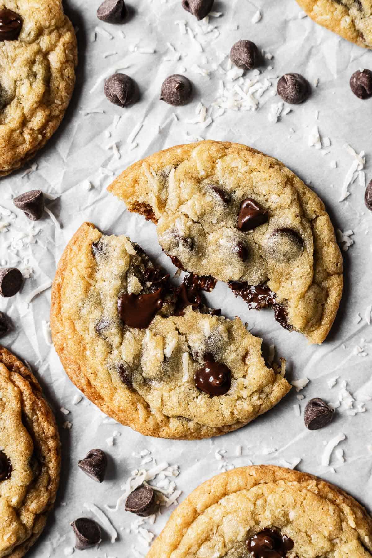 A large cookie split in half showing melted chocolate chips and a gooey center.