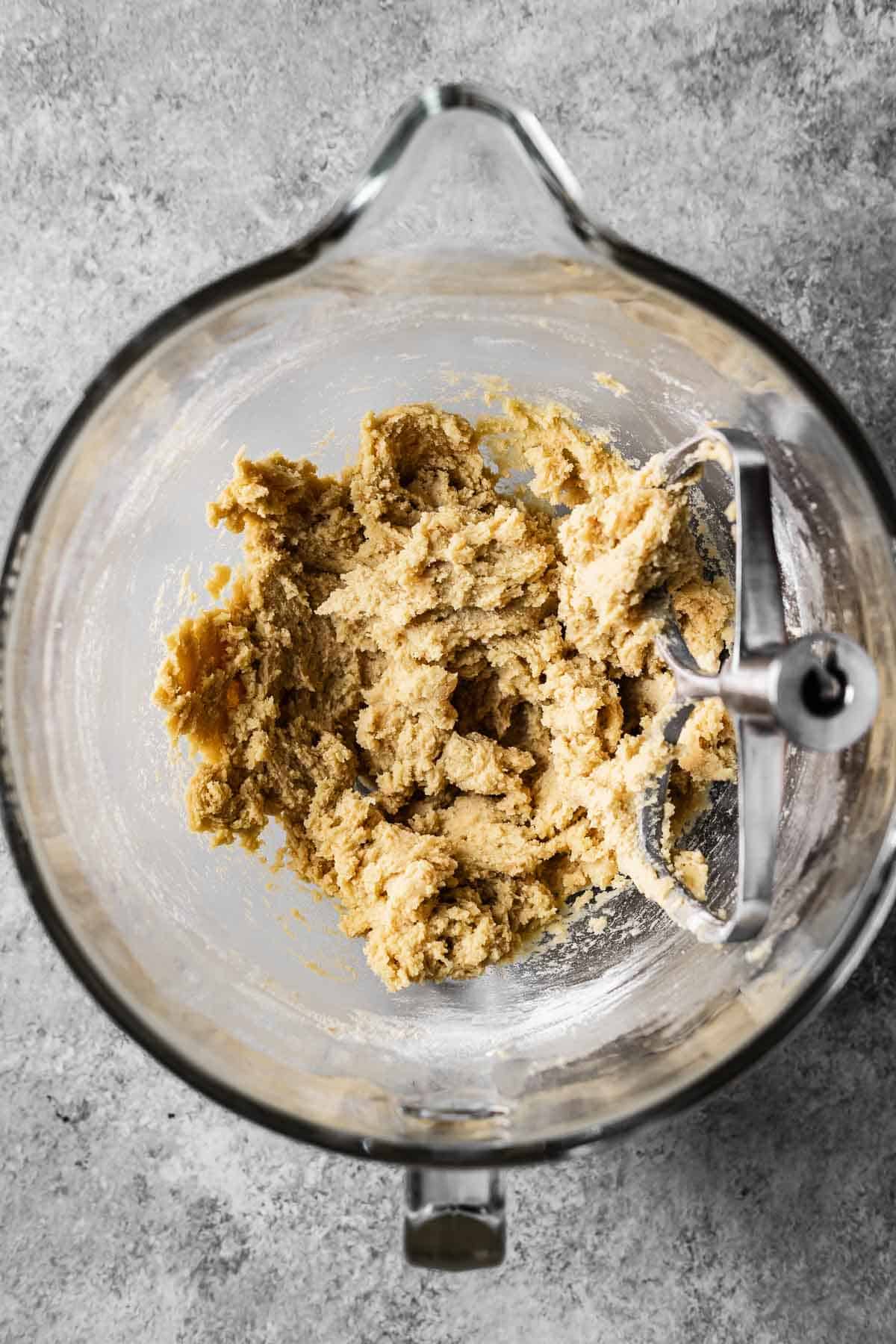 A mixing bowl of plain cookie dough without add ins.