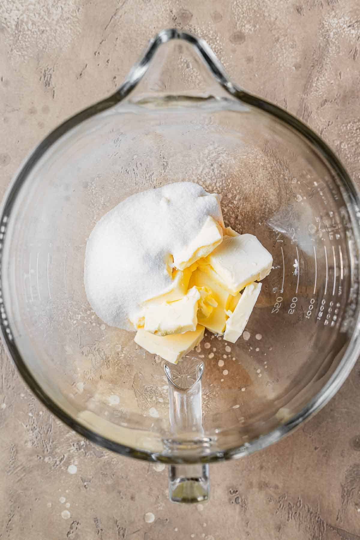 Sugar and butter in a mixing bowl.