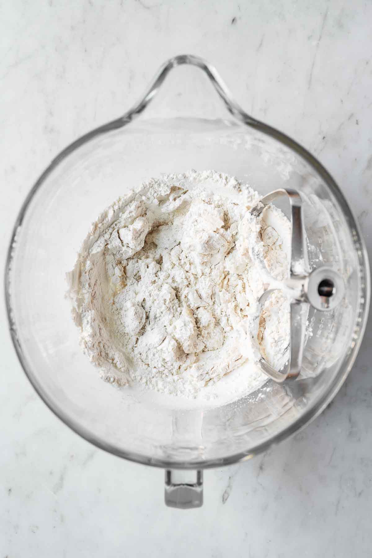 Dry ingredients added to wet in a glass mixing bowl.
