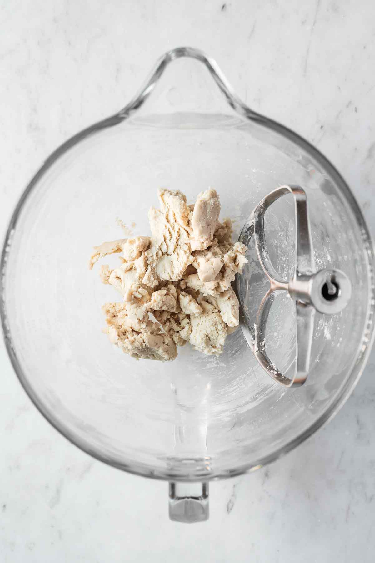 Finished Golden Oreo cookie dough in a glass mixing bowl.