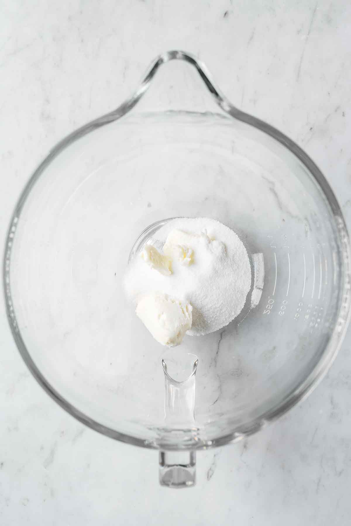 Shortening and sugar in a glass mixing bowl.