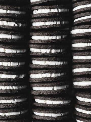 Three rows of vanilla creme filled chocolate sandwich cookies.