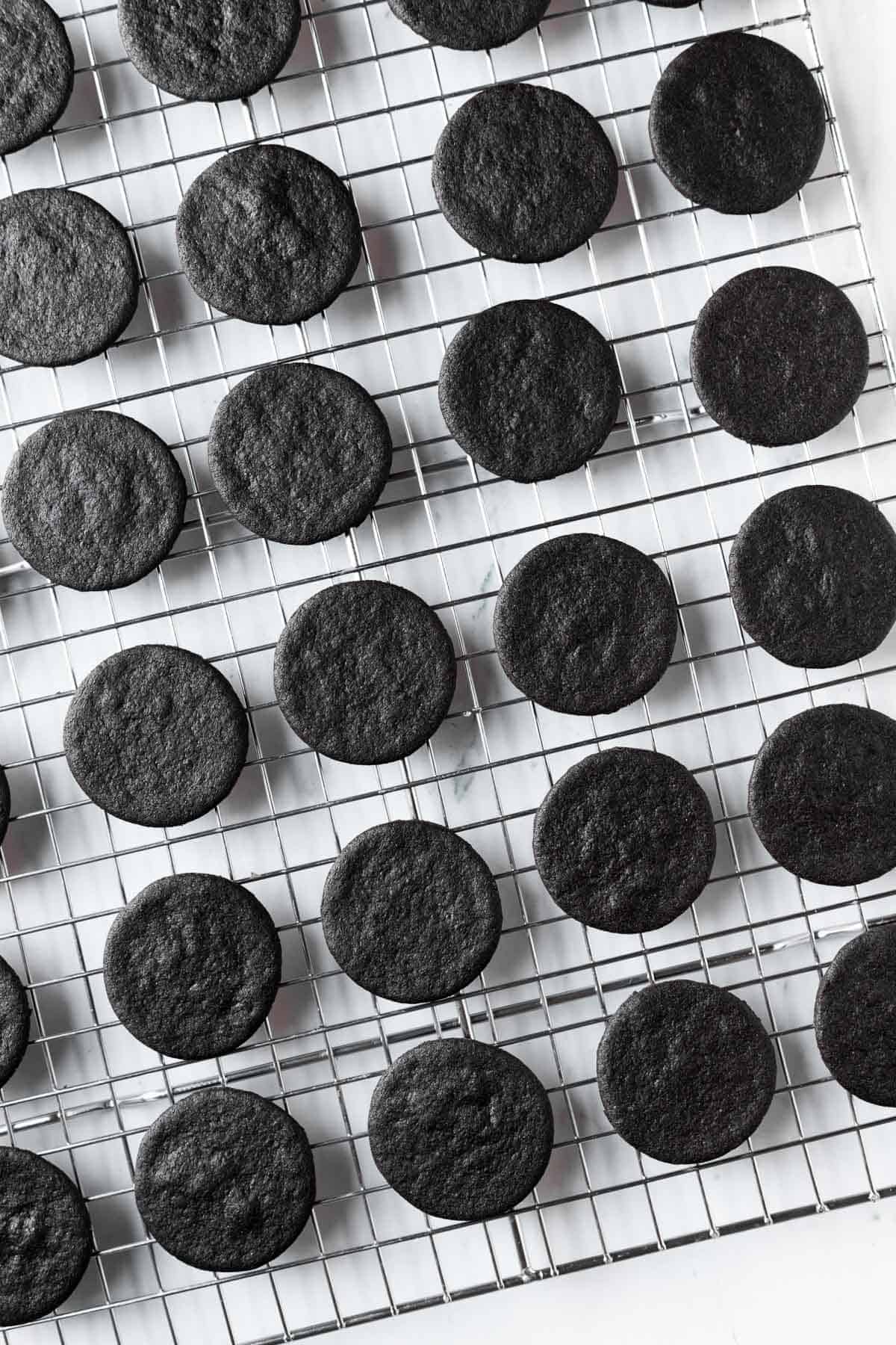Baked homemade Oreo cookies on a cooling rack.