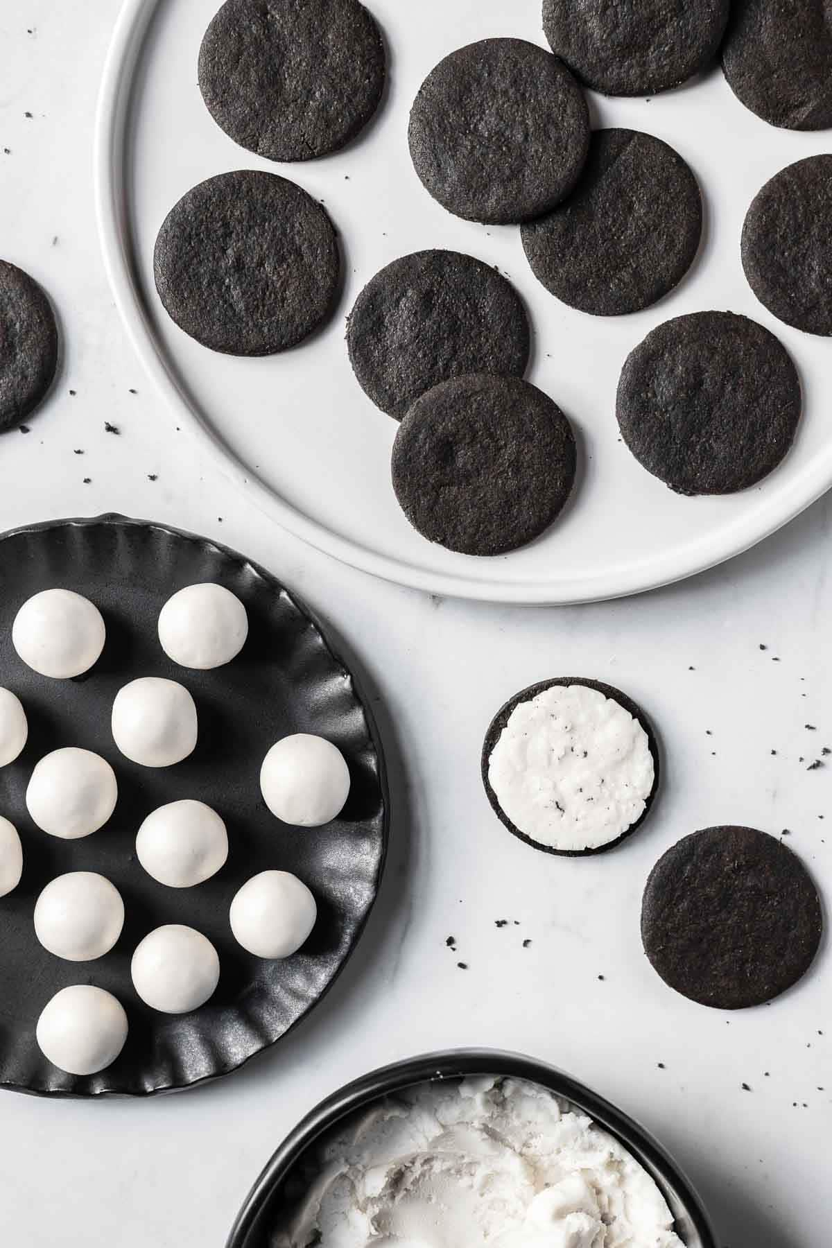 Chocolate cookies and Oreo filling with one cookie opened face up.