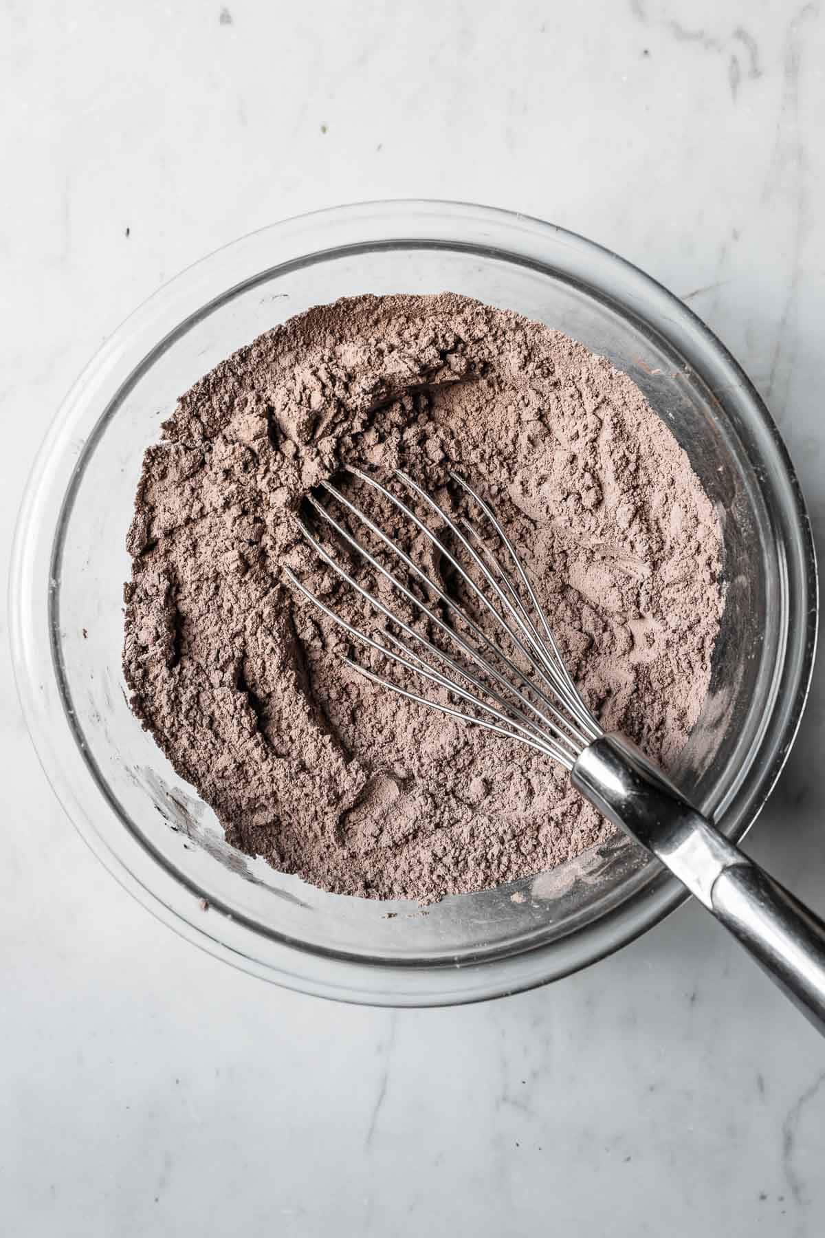 Dry ingredients whisked in a glass mixing bowl.