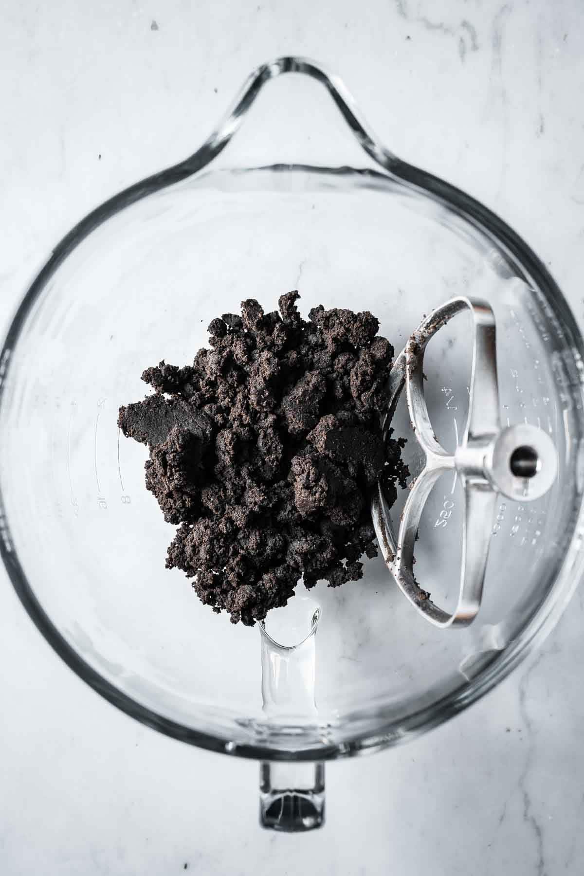 Finished Oreo cookie dough in a glass mixing bowl.