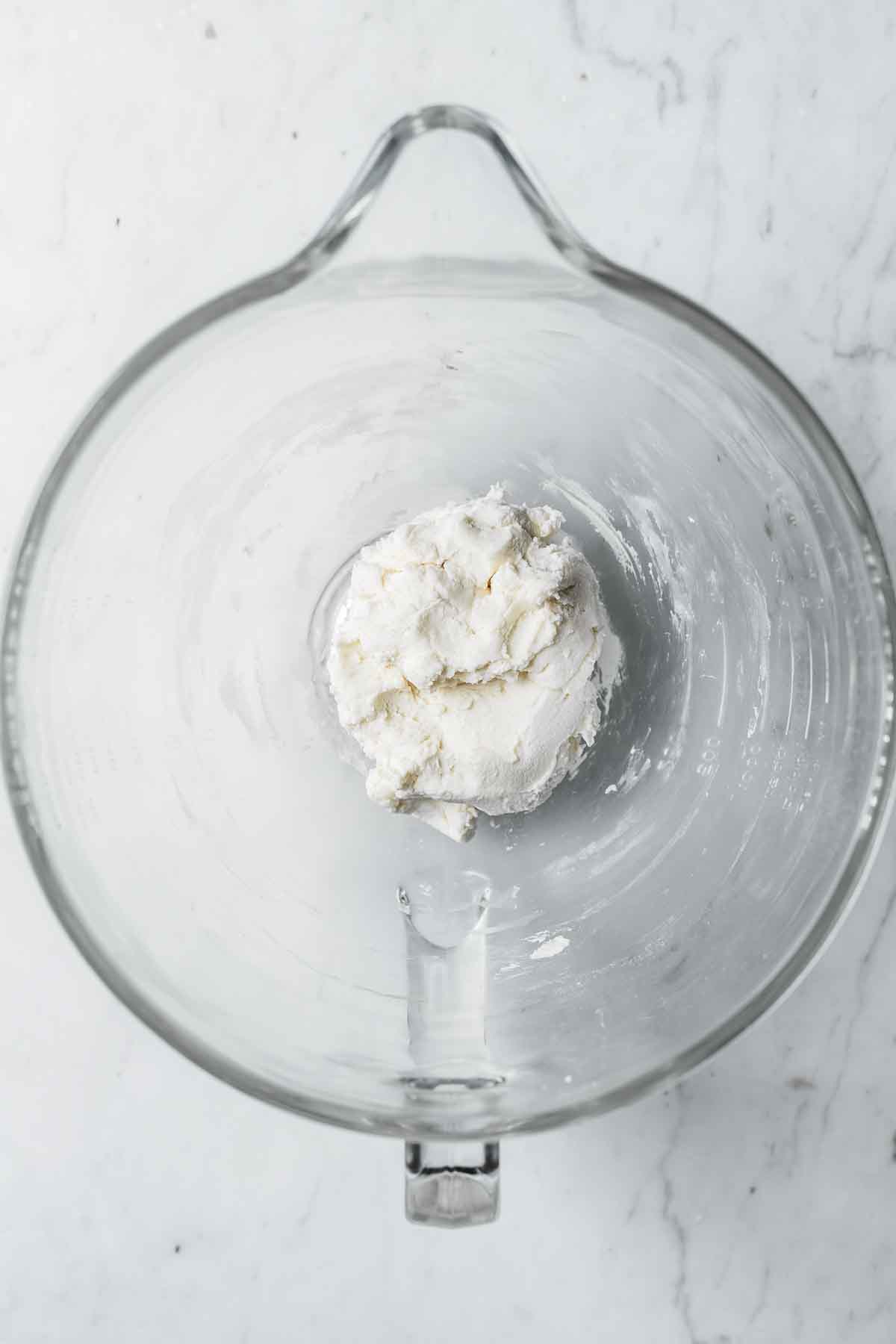 Finished Oreo cookie filling in a glass mixing bowl.