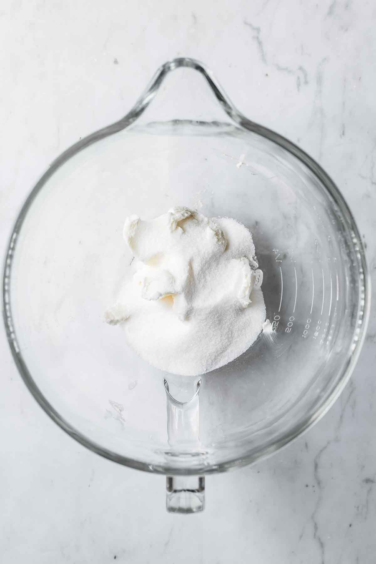 Shortening and sugar in a glass mixing bowl.
