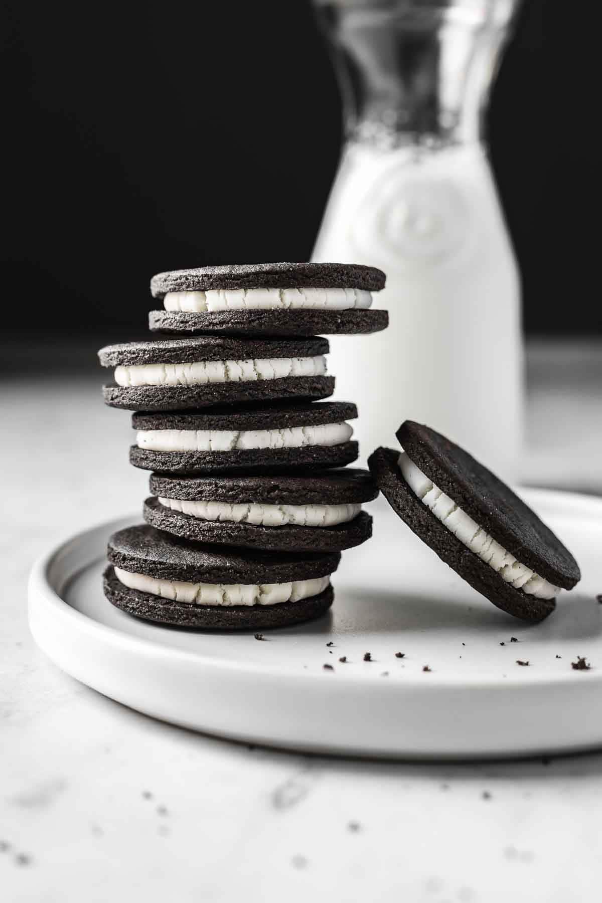 A stack of homemade Oreos on a white plate.