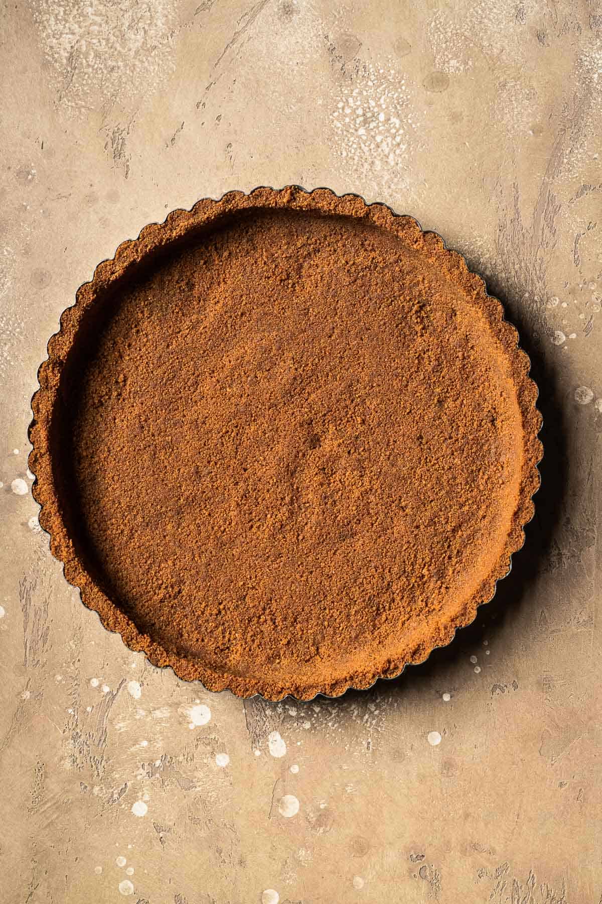 A baked biscoff cookie tart crust.