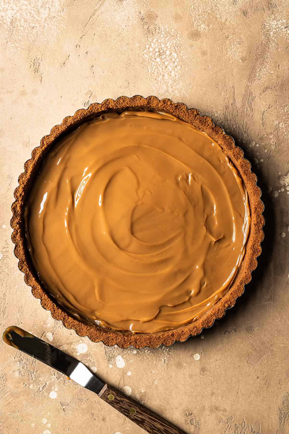 Dulce de leche in the base of a biscoff crust.