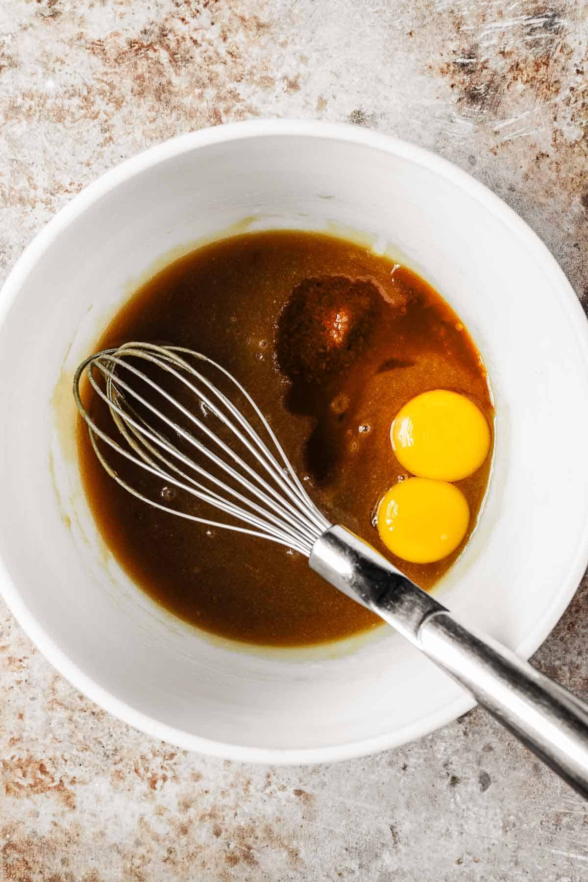 Eggs, vanilla and salt added to batter in a mixing bowl.
