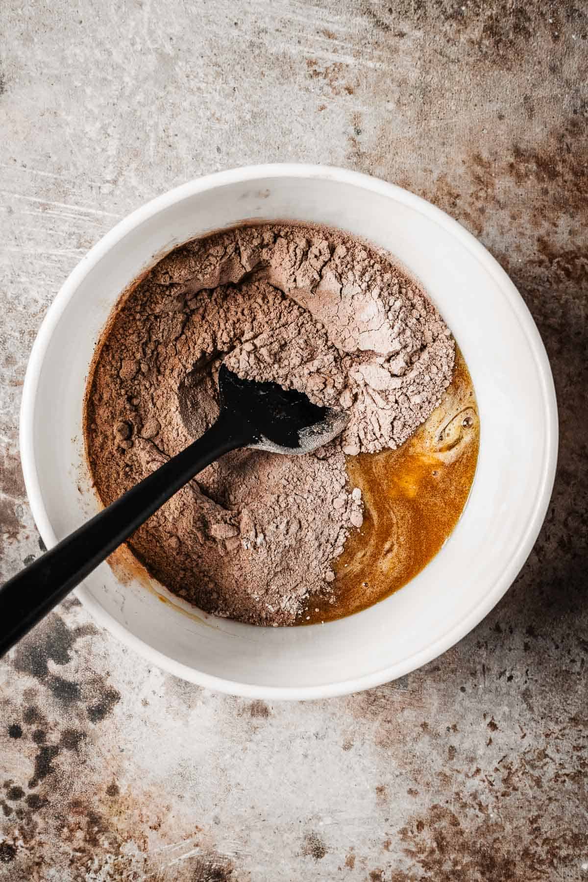A mixing bowl with wet and dry ingredients.