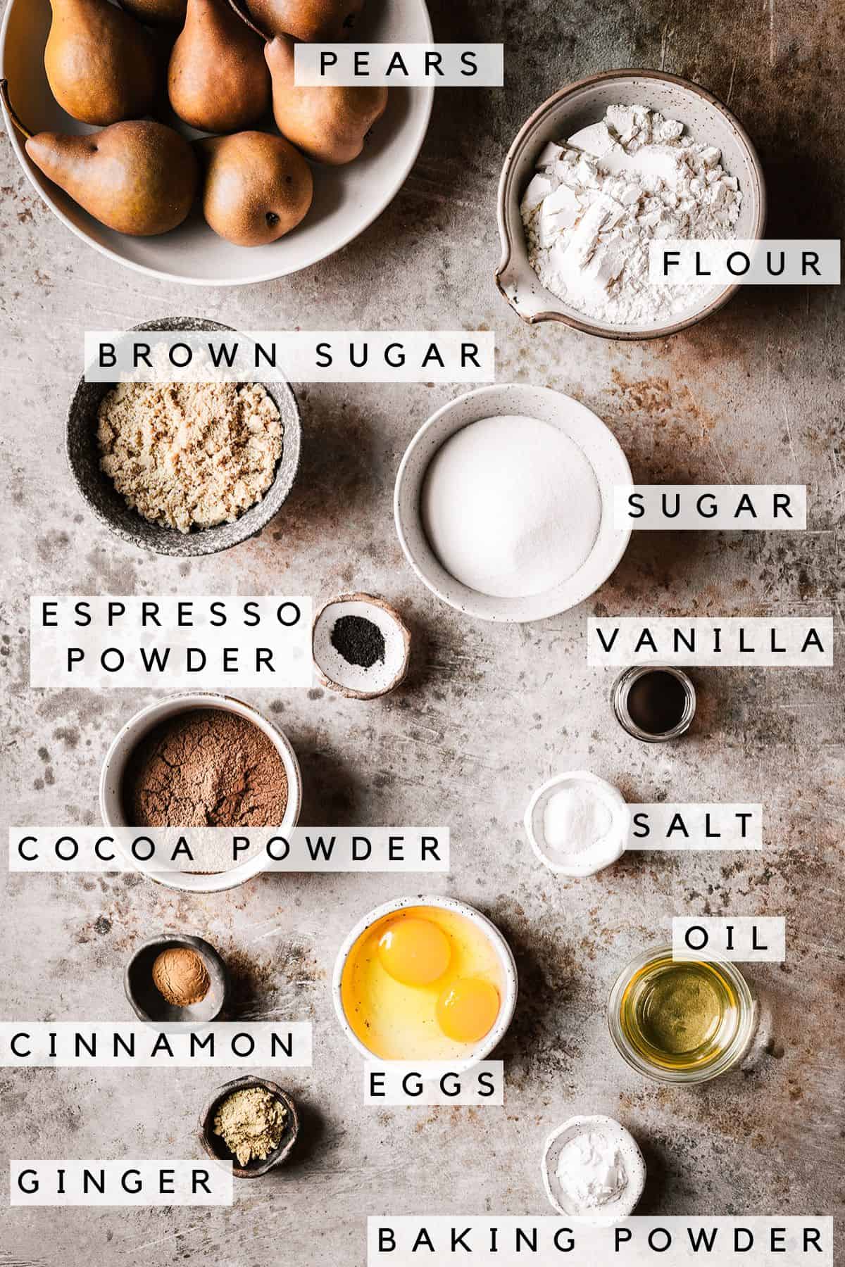 Containers of ingredients for chocolate pear cake with labels.