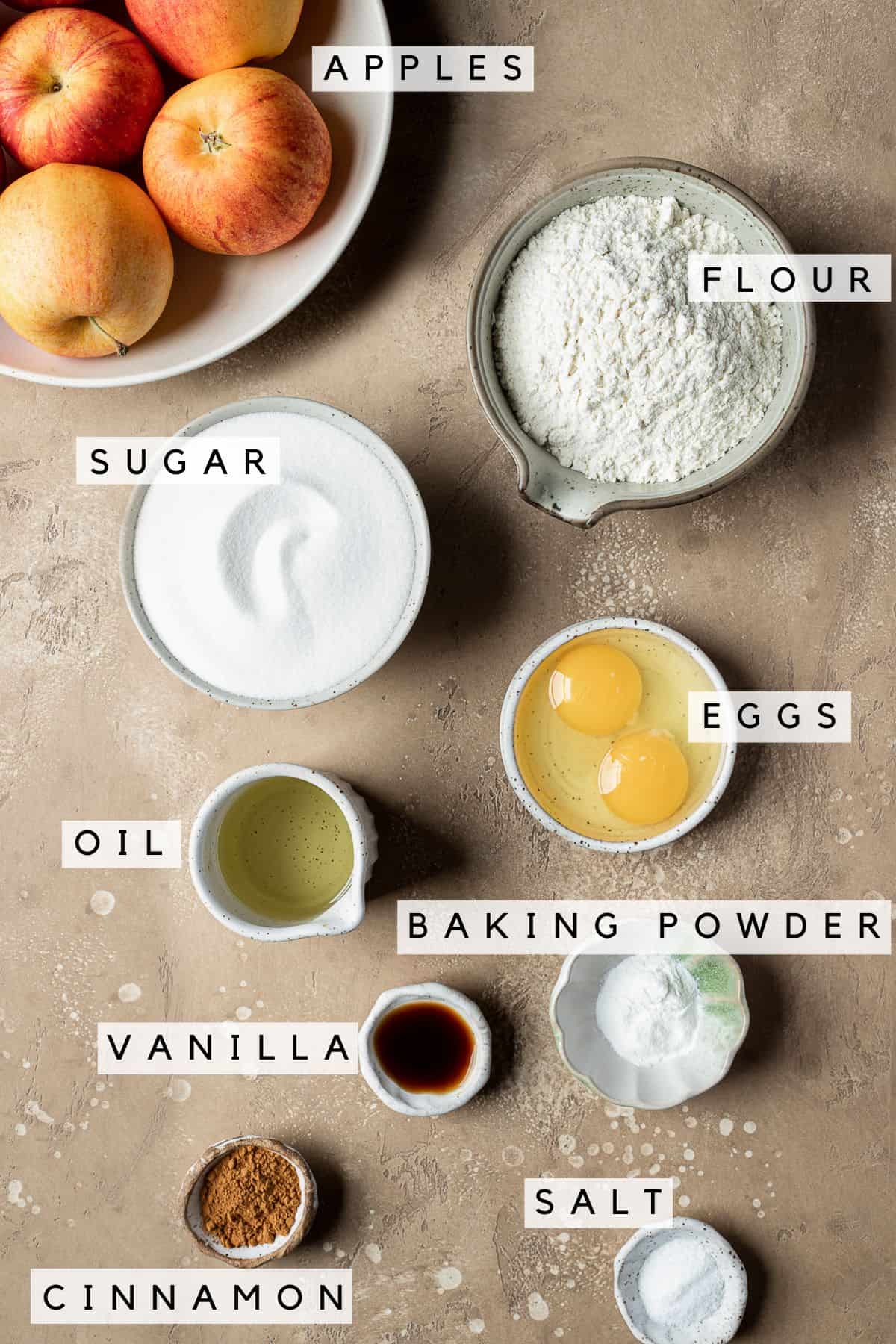 Labeled bowls of ingredients for moist apple cake.