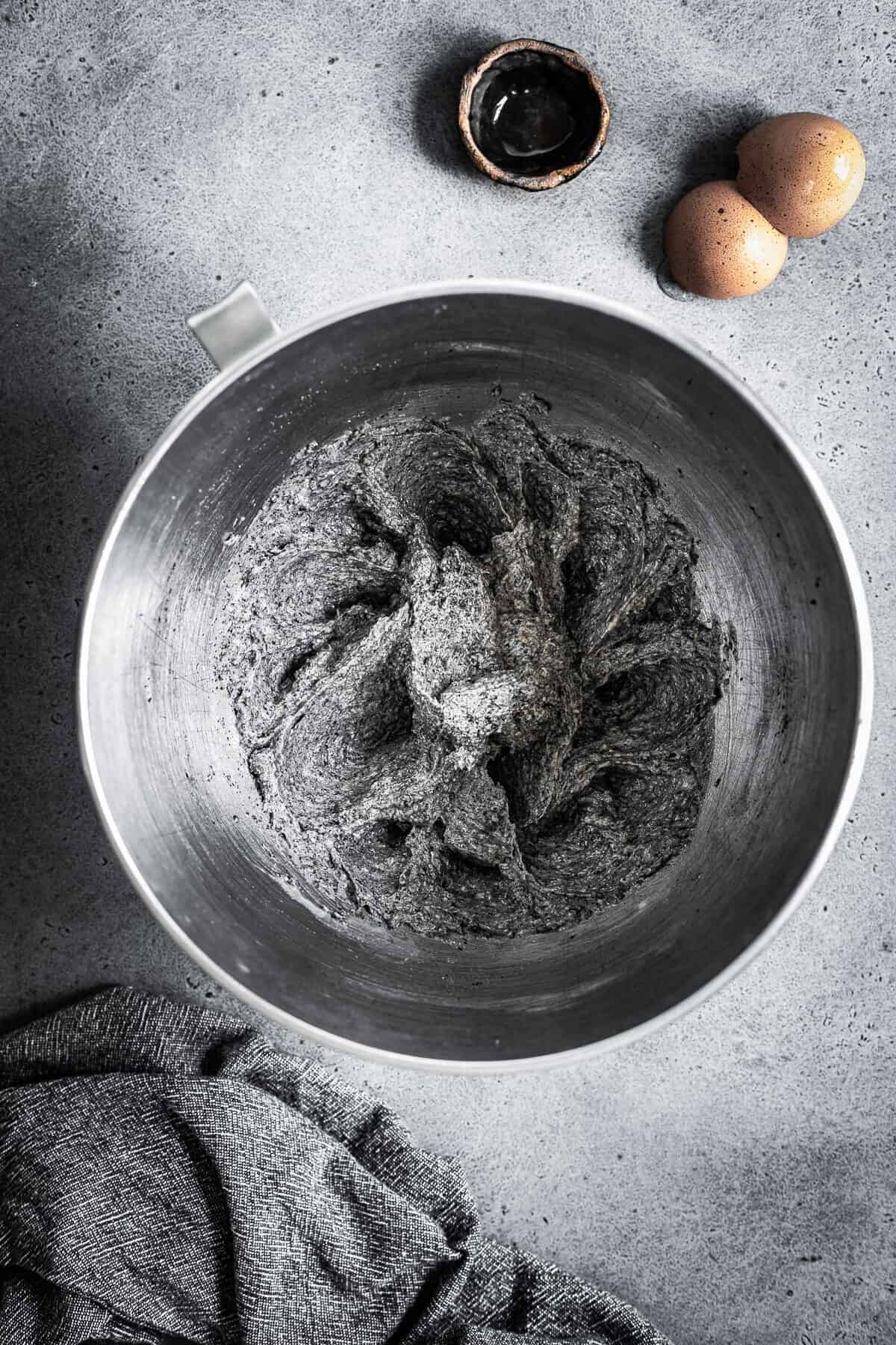 A mixing bowl with butter, sugar, eggs and vanilla mixed together.