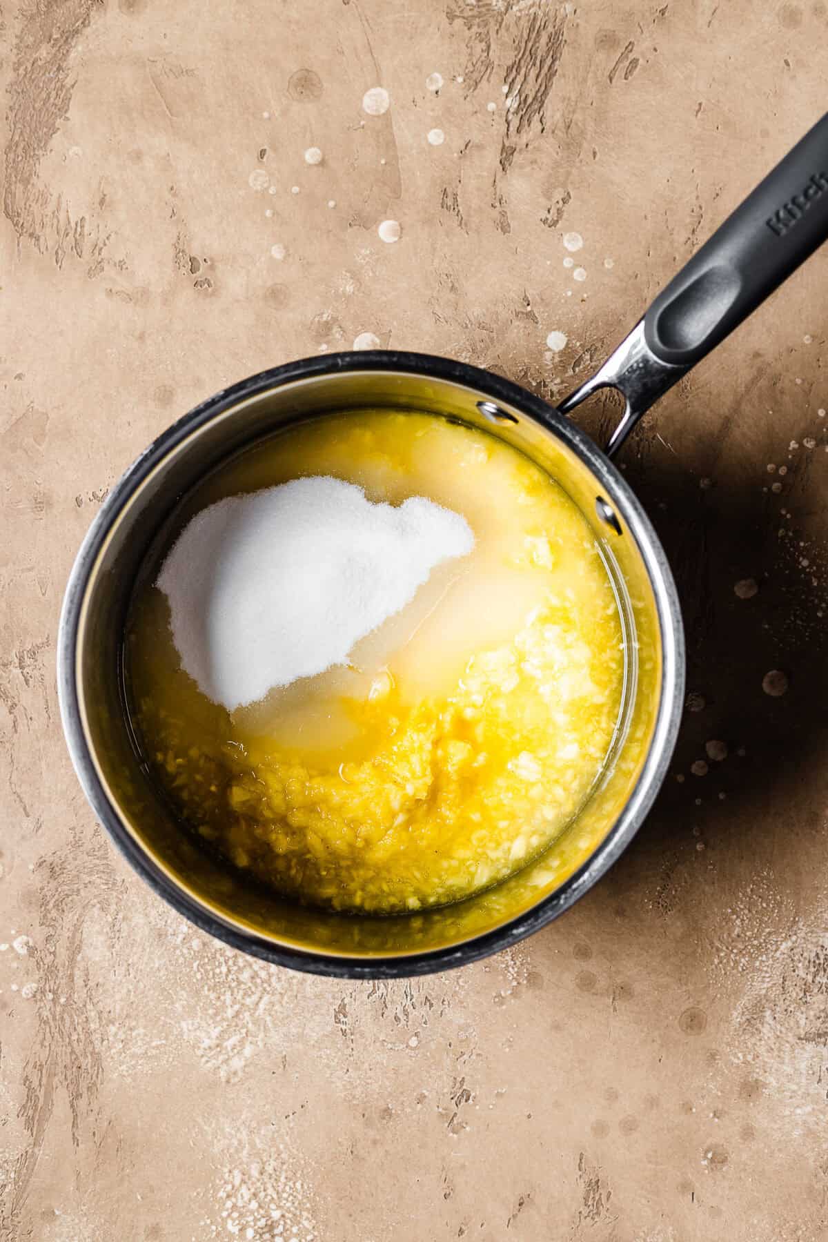 Fresh pineapple puree, granulated sugar and lime juice in a pot.