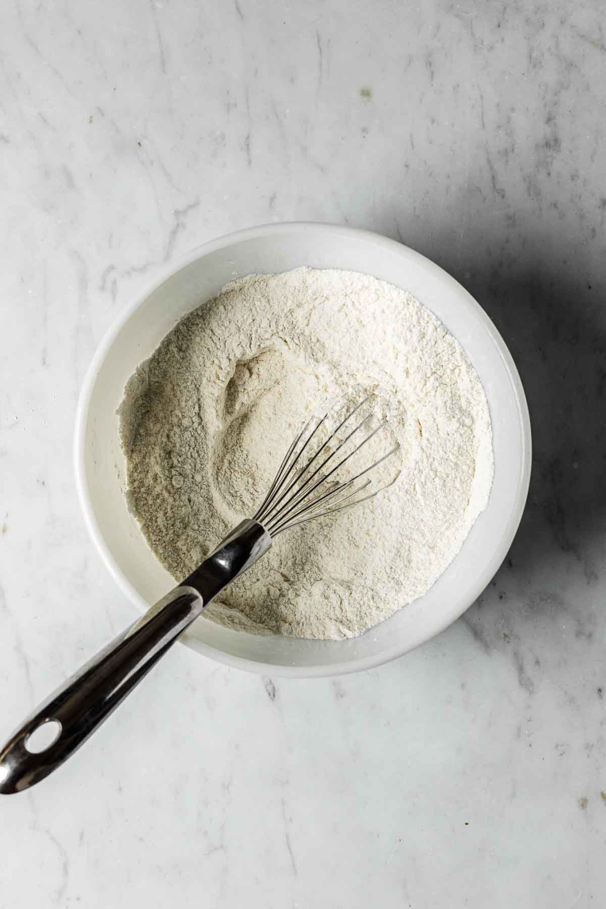 A mixing bowl with dry ingredients for macarons.