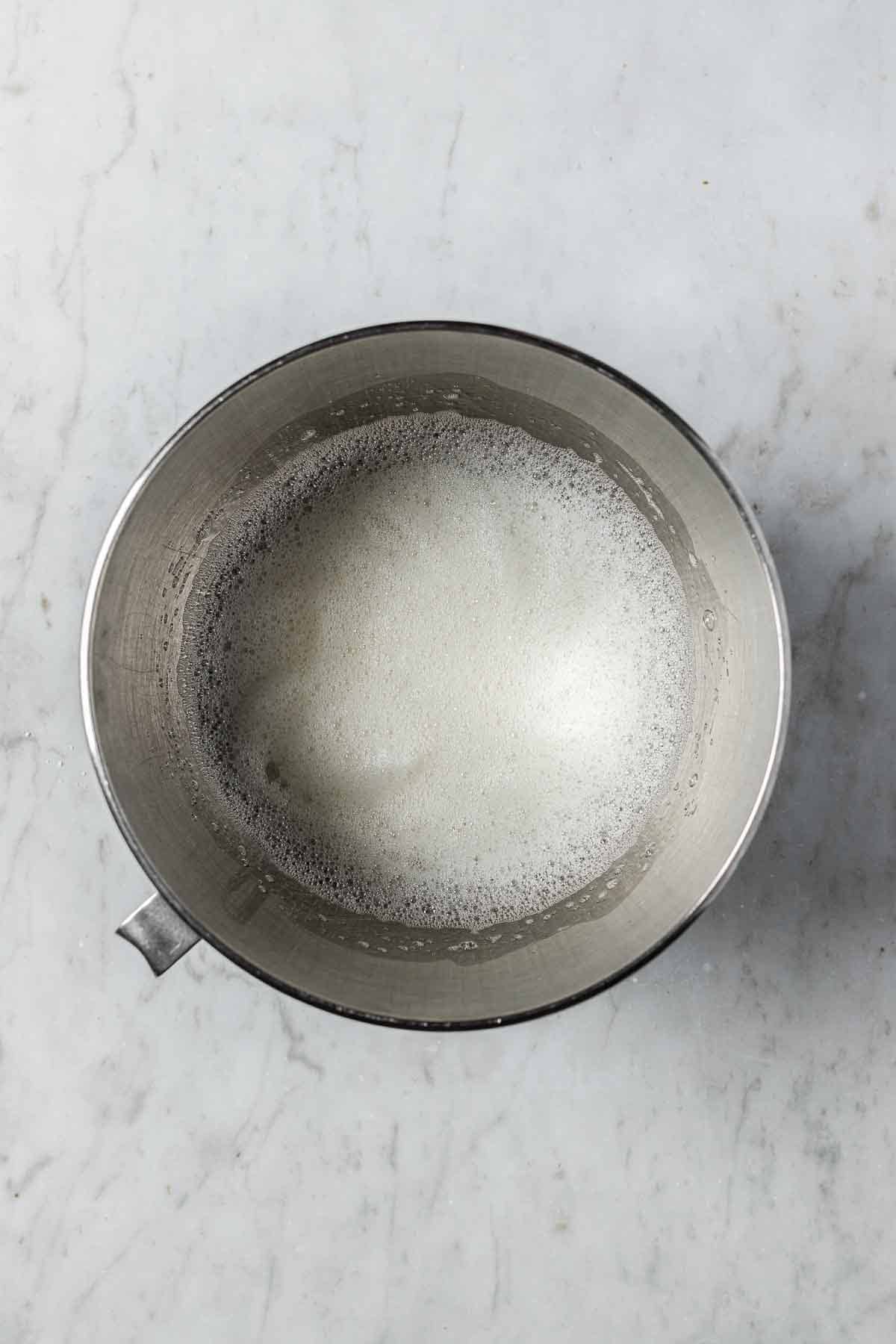A mixing bowl with frothy egg whites for meringue.