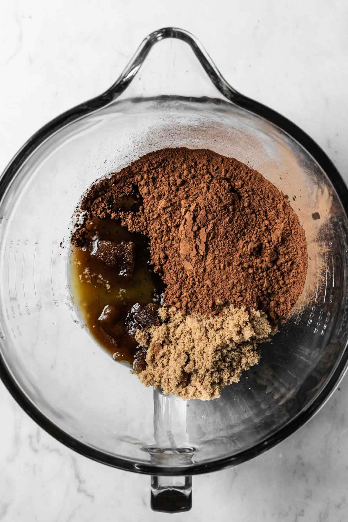 Melted butter, brown sugar and cocoa powder in a glass mixing bowl.