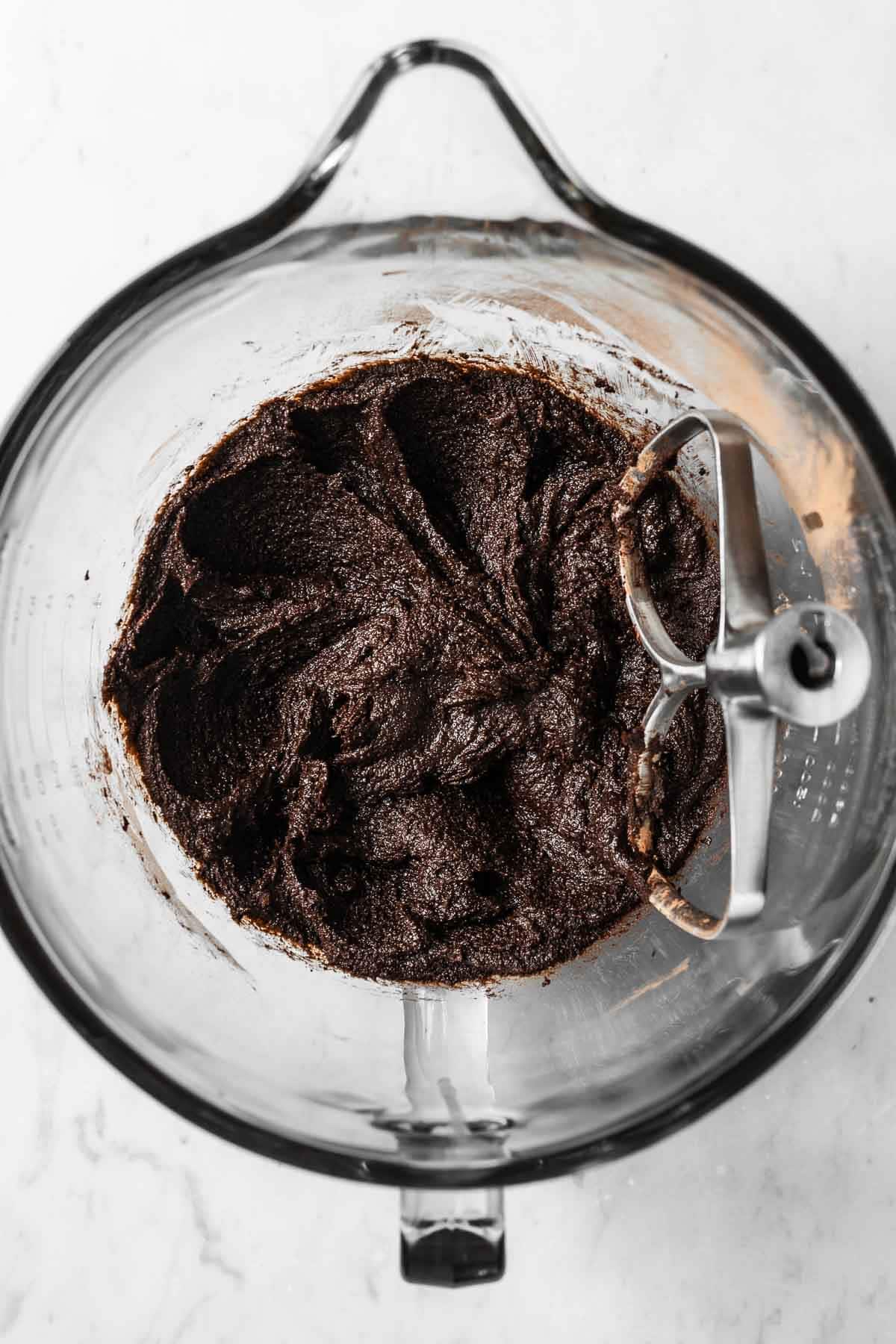 Melted butter, brown sugar and cocoa powder in a glass mixing bowl.