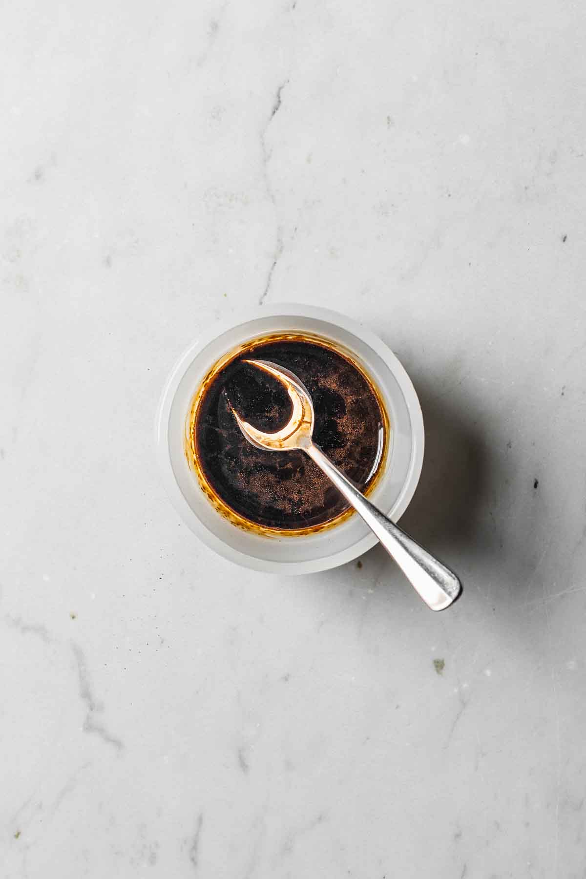 Espresso powder and vanilla extract mixed together in a small bowl.