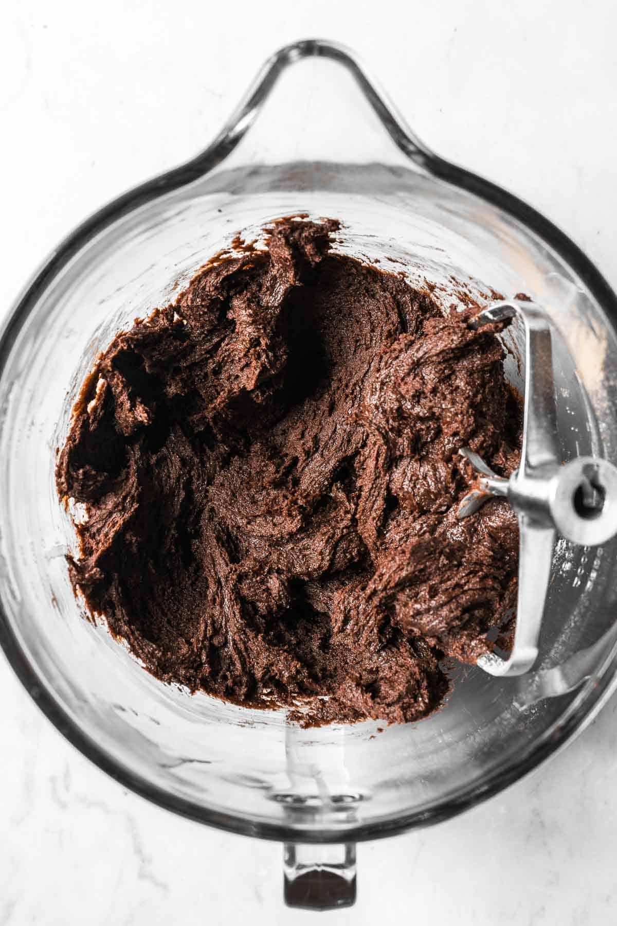 Chocolate mascarpone cookie dough in a glass mixing bowl.