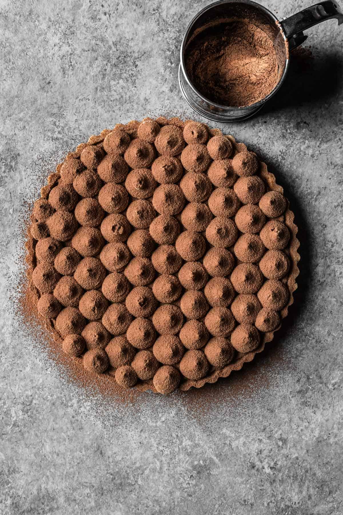 A chocolate coffee mascarpone tart dusted with natural cocoa powder.