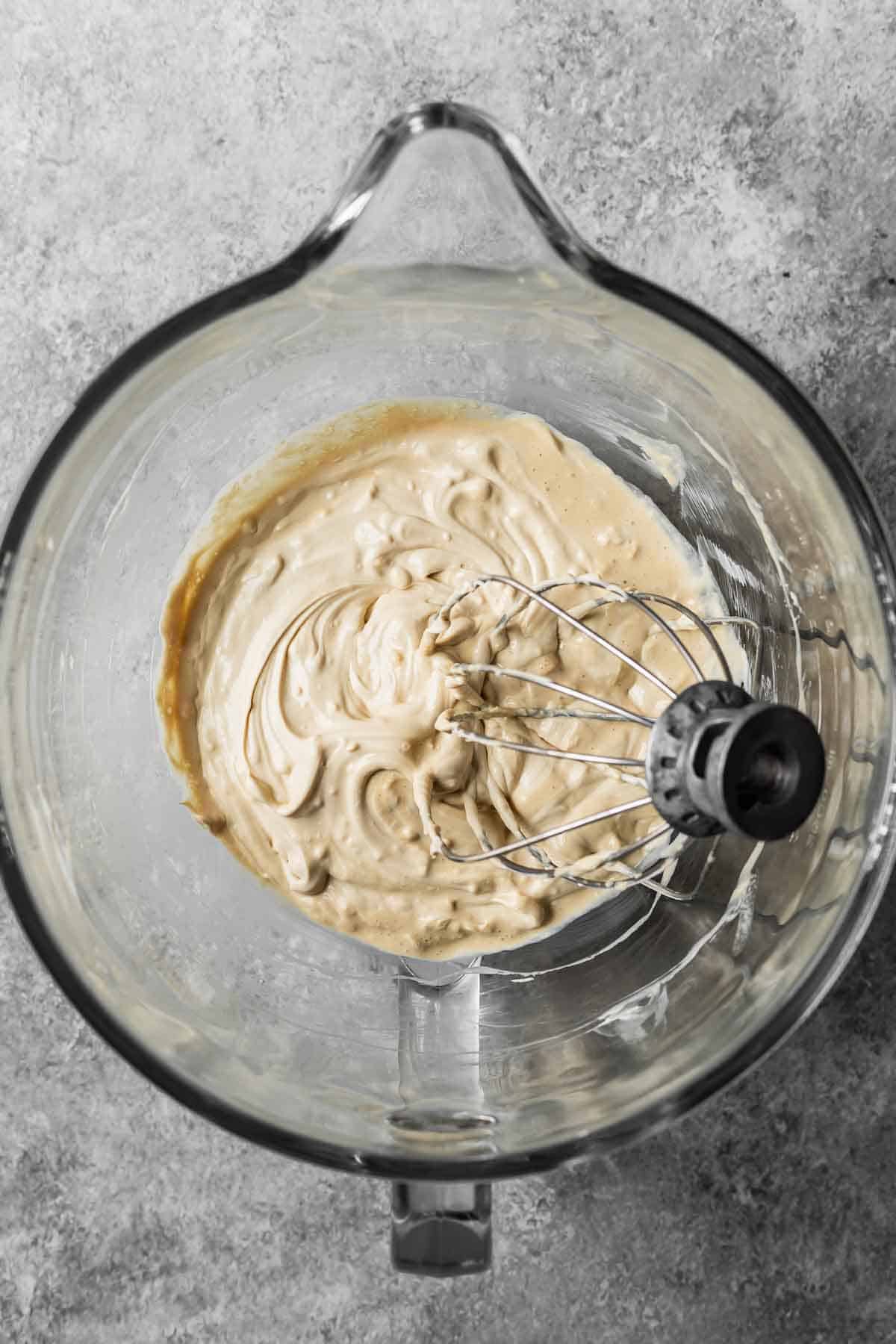 Cream and espresso powder mixture added to mascarpone cheese and whisked until soft peaks form.
