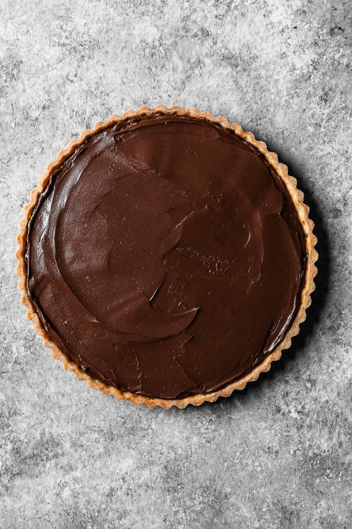 A blind baked tart shell smoothly filled with chocolate ganache mixed with mascarpone.