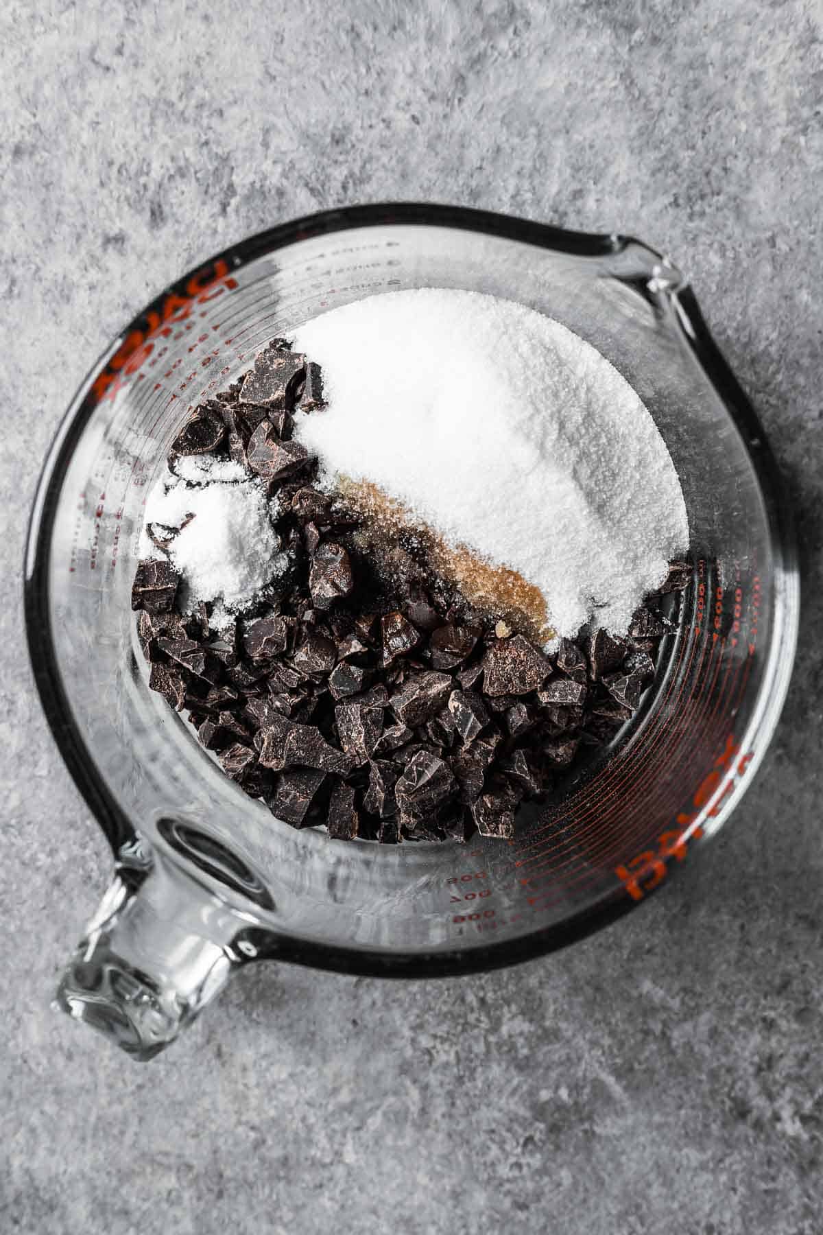 Chopped dark chocolate, sugar, vanilla and salt in a glass measuring container.