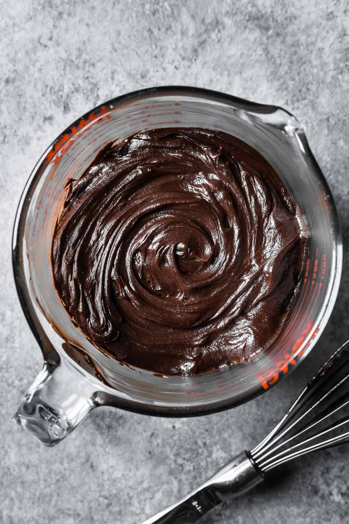 Finished chocolate mascarpone ganache in a large glass container.