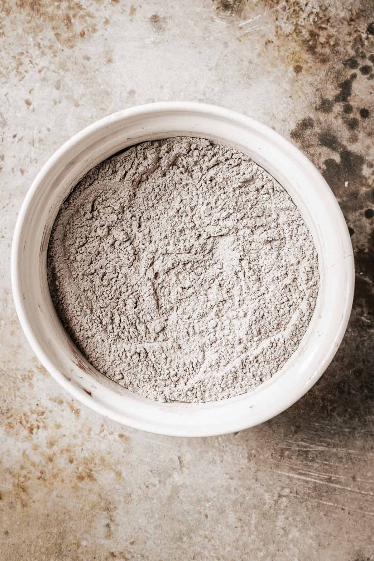 Dry ingredients mixed together in a white ceramic bowl.