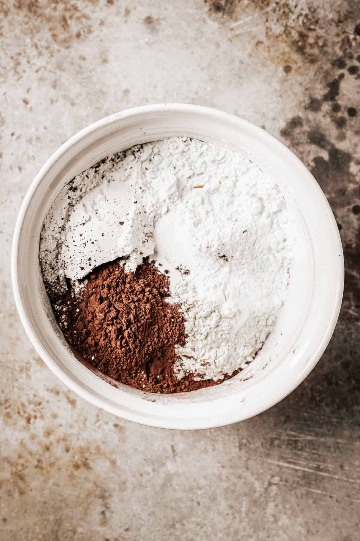 Unmixed dry ingredients in a white ceramic bowl.
