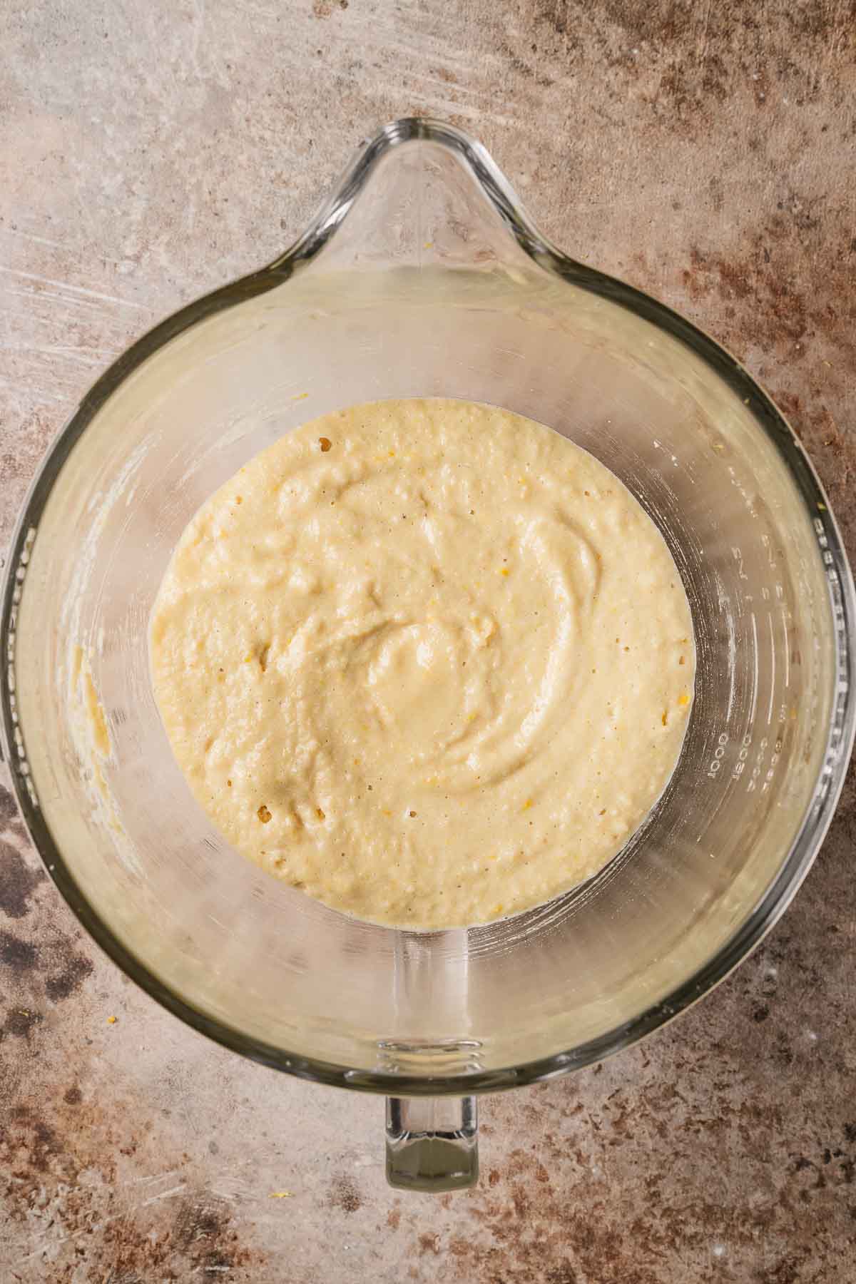 Finished batter for almond cake in a clear glass mixing bowl.